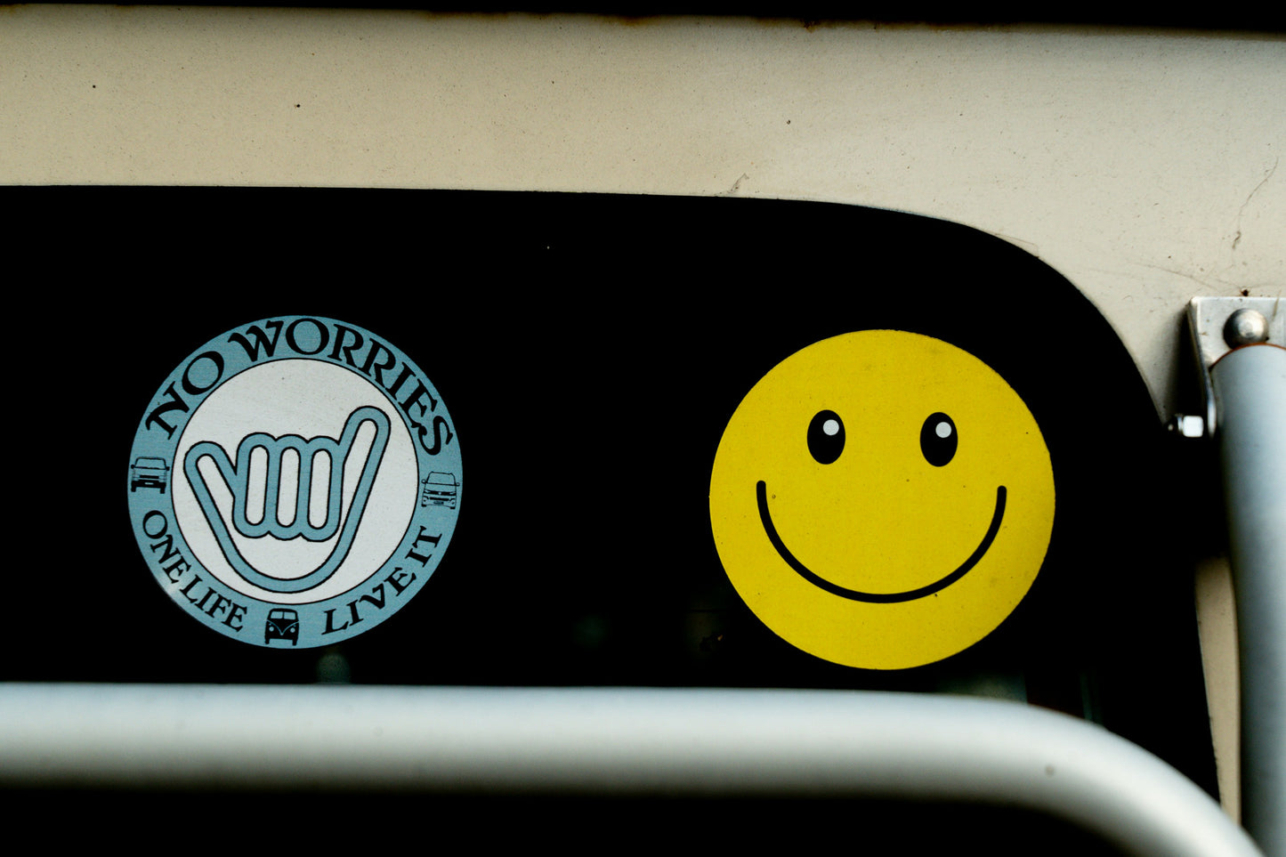 Sticker with 'No Worries' logo and smiley face on a vehicle.
